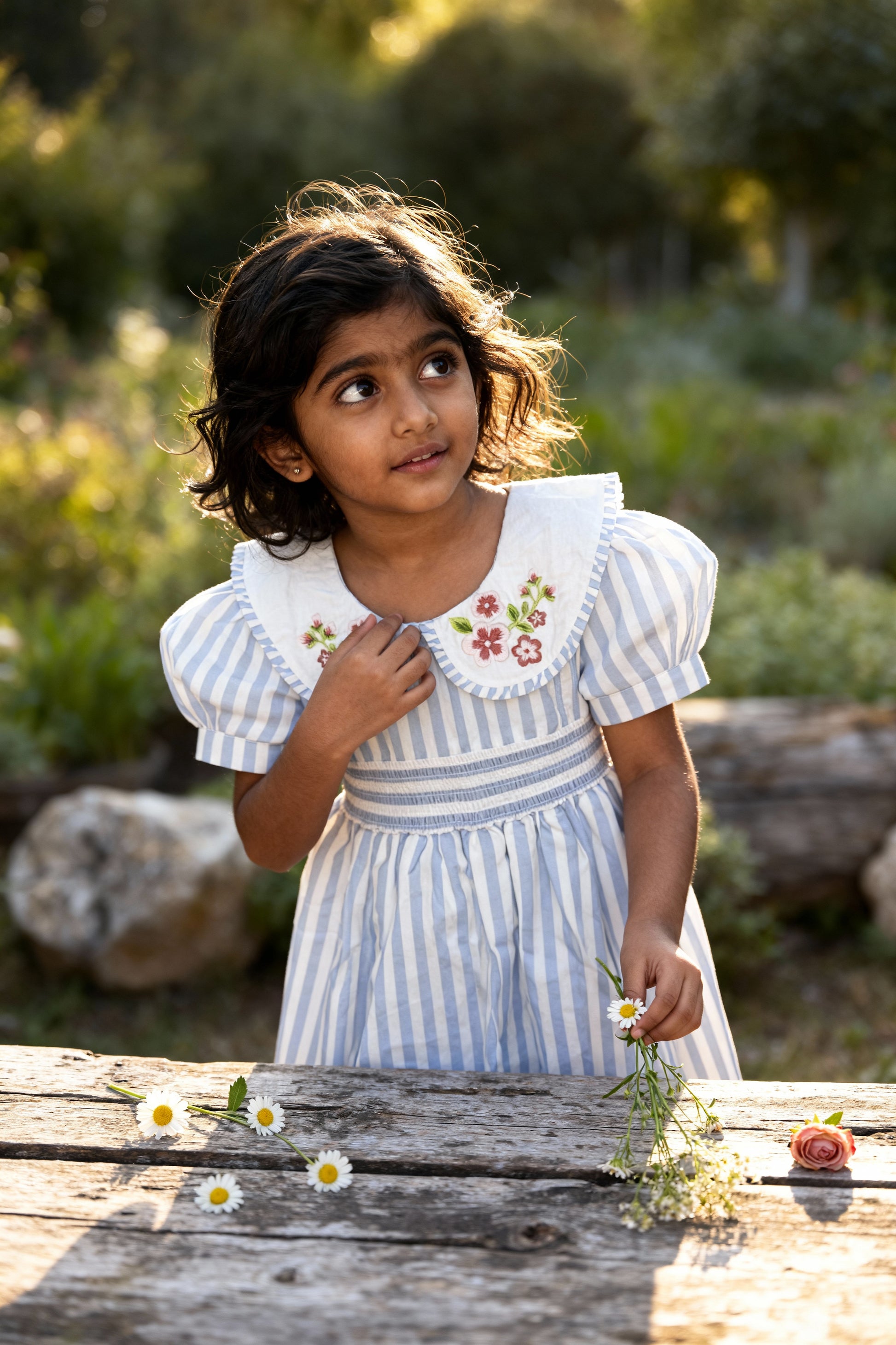 Portofino organic cotton smocked striped girls dress flat lay showing blue-and-white striped GOTS-certified fabric