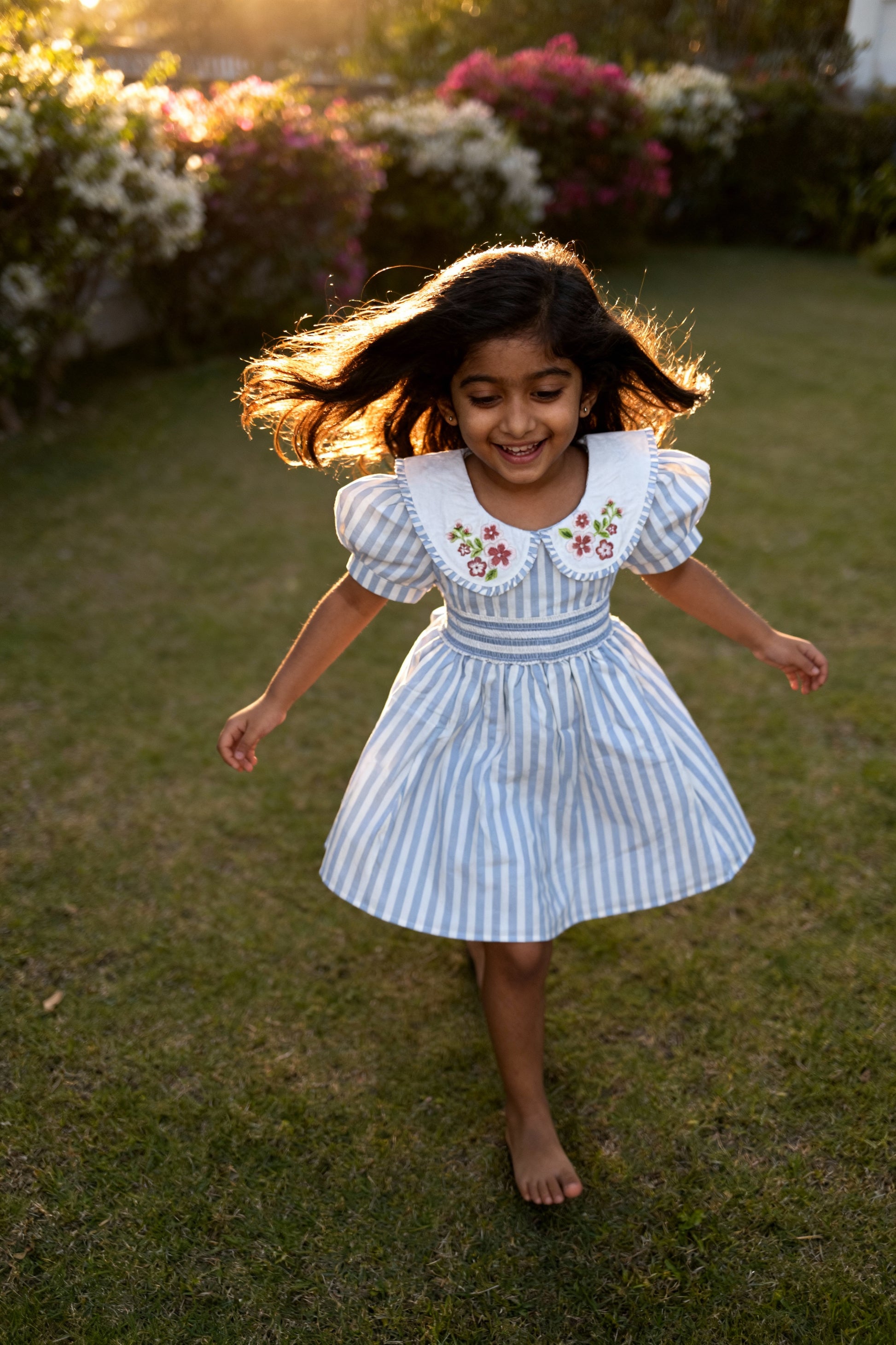 Portofino organic cotton smocked striped girls dress back view showing smocking elasticity