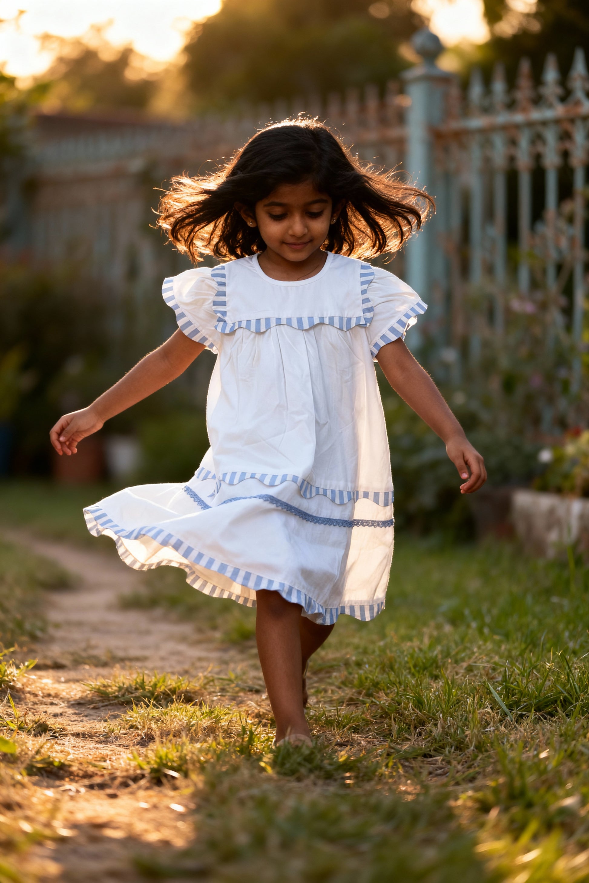 Santorini organic cotton flutter-sleeve girls dress flat lay of GOTS-certified white cotton fabric