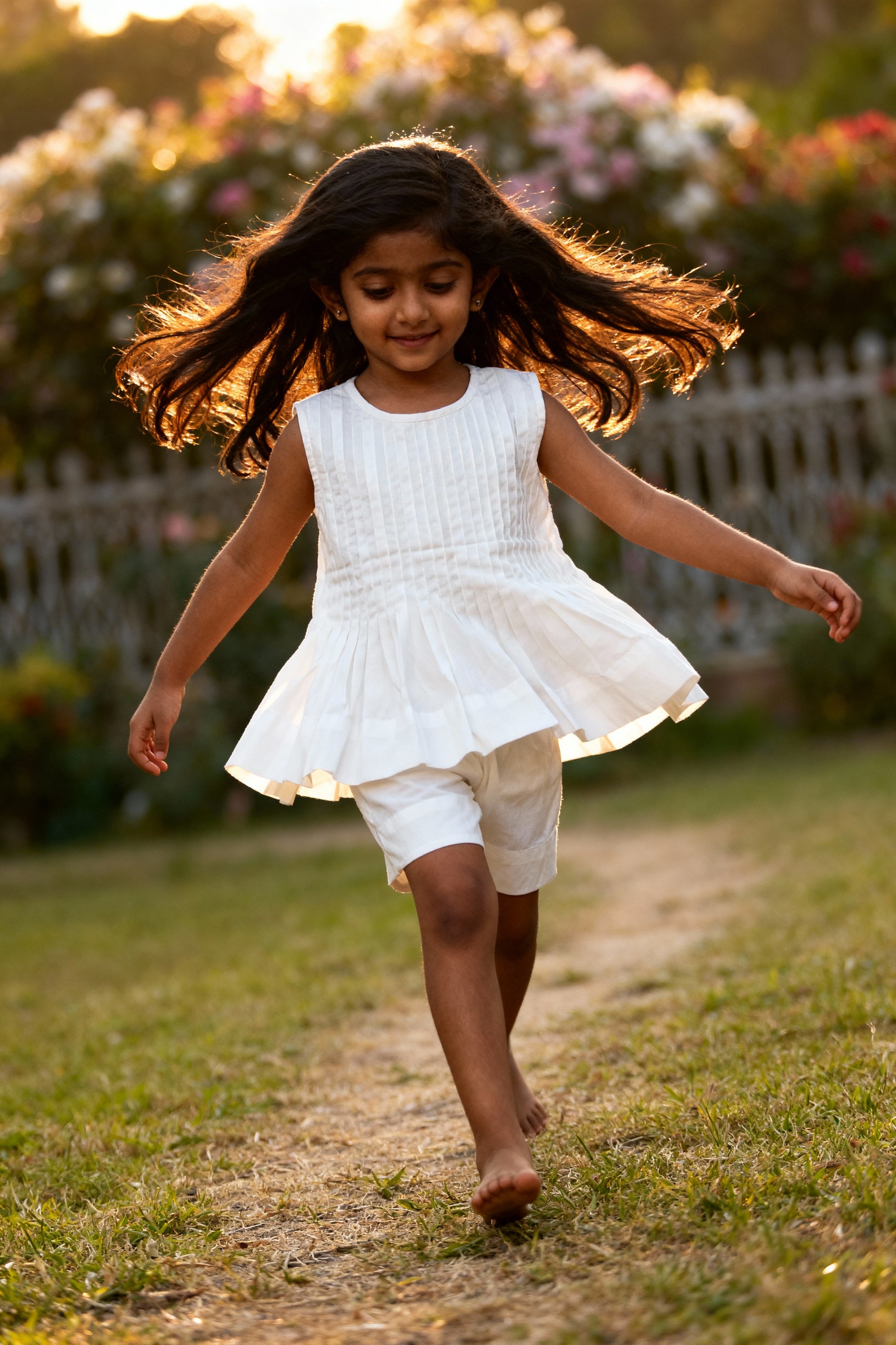Vienna organic cotton pleated girls blouse front view with elegant pleated detailing in white