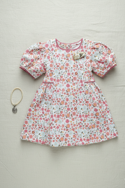 Riviera Rose organic cotton-linen floral puff-sleeve girls dress back view showing bow tie detail