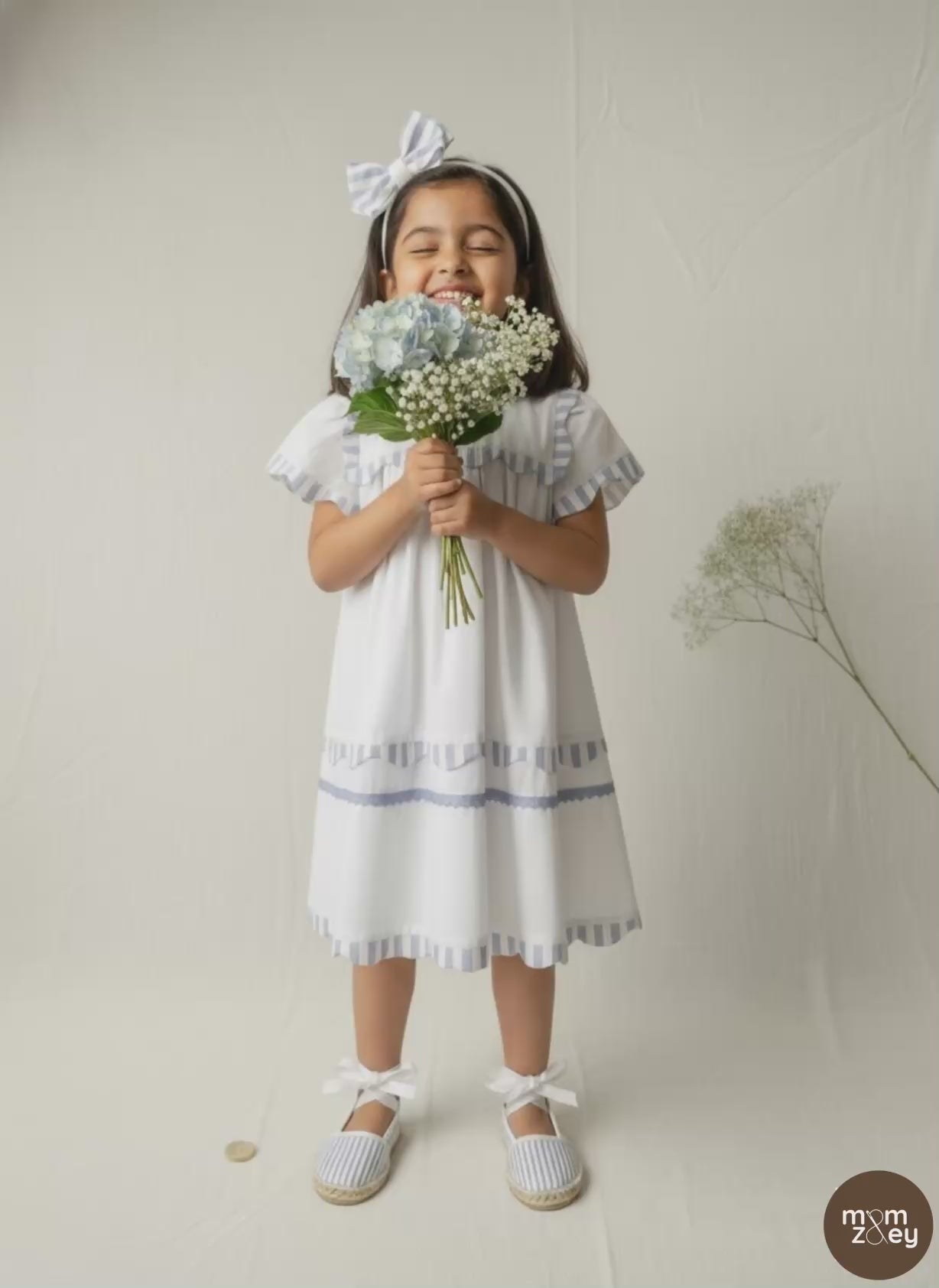 Santorini organic cotton flutter-sleeve girls dress video showing breezy movement and fabric drape